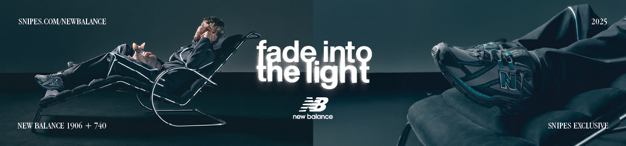 model laying on chair wearing black new balance 1906 sneakers and aparel