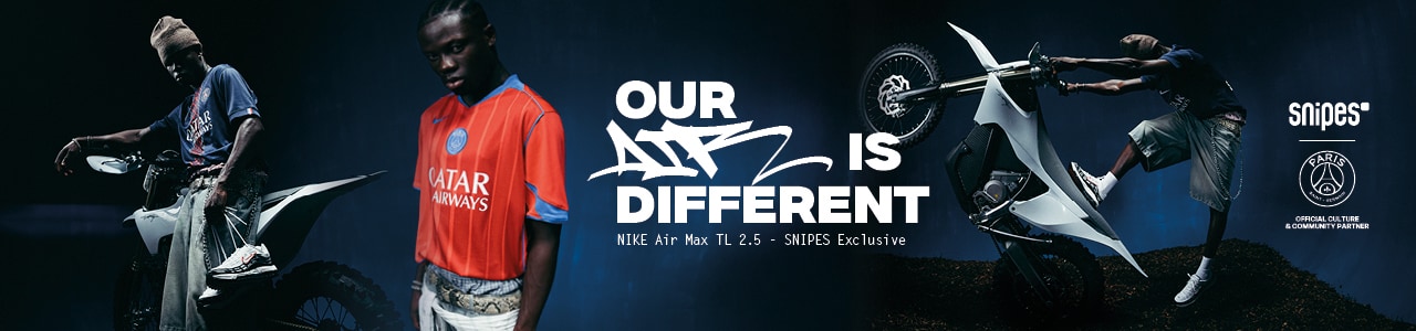 A promotional poster featuring a person holding up a white and gray Nike Air Max TL 2.5 sneaker with a red swoosh, standing in front of a motorcycle. Bold text at the top reads, "OUR AIR IS DIFFERENT," followed by "NIKE Air Max TL 2.5 - SNIPES Exclusive." The SNIPES logo and other branding appear at the bottom.