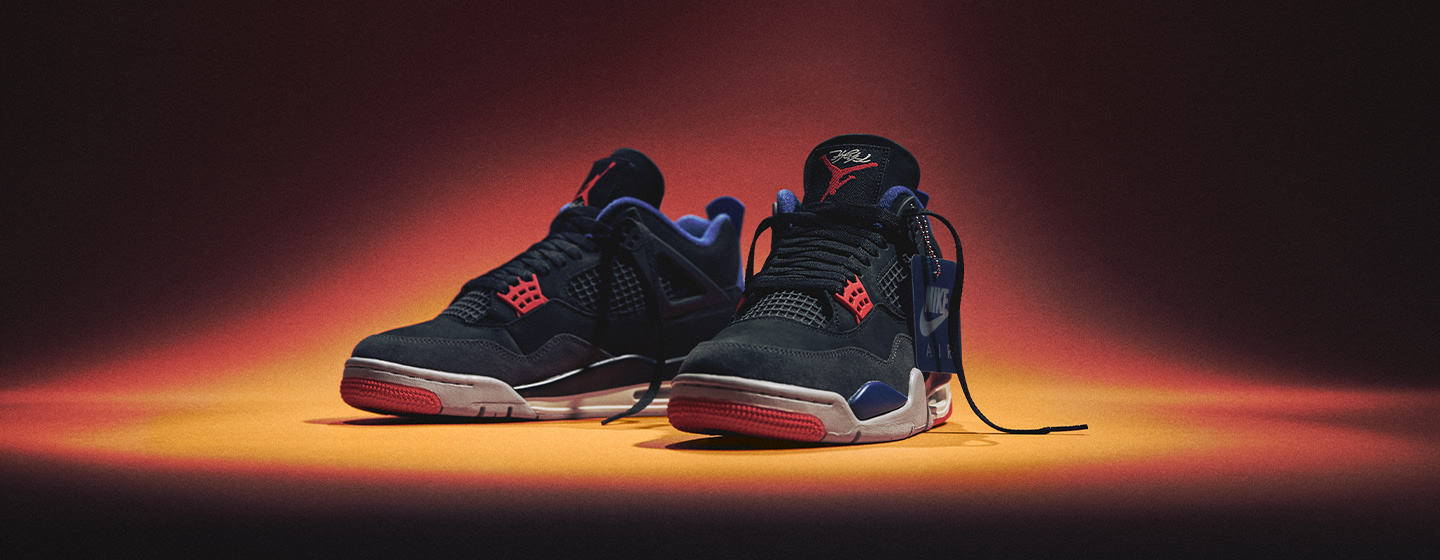 Air Jordan 4 Retro "RARE AIR" black and red, on a orange and black background