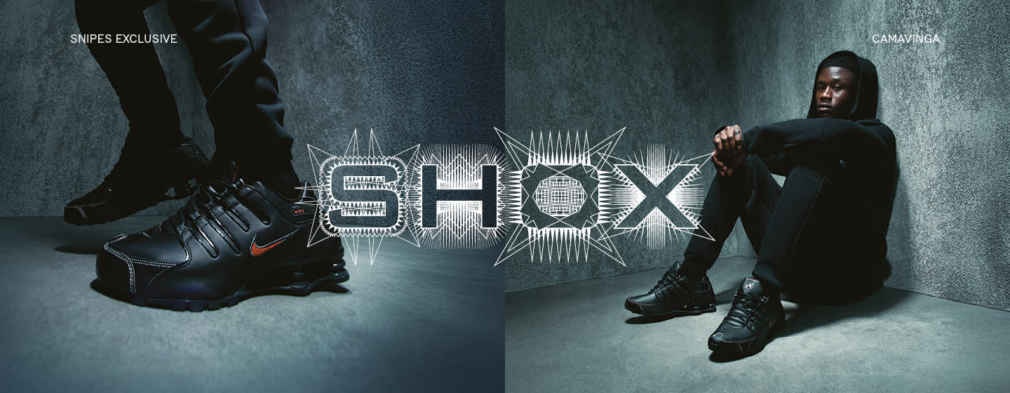 Model wearing nike Shox Z Sneakers in white and black