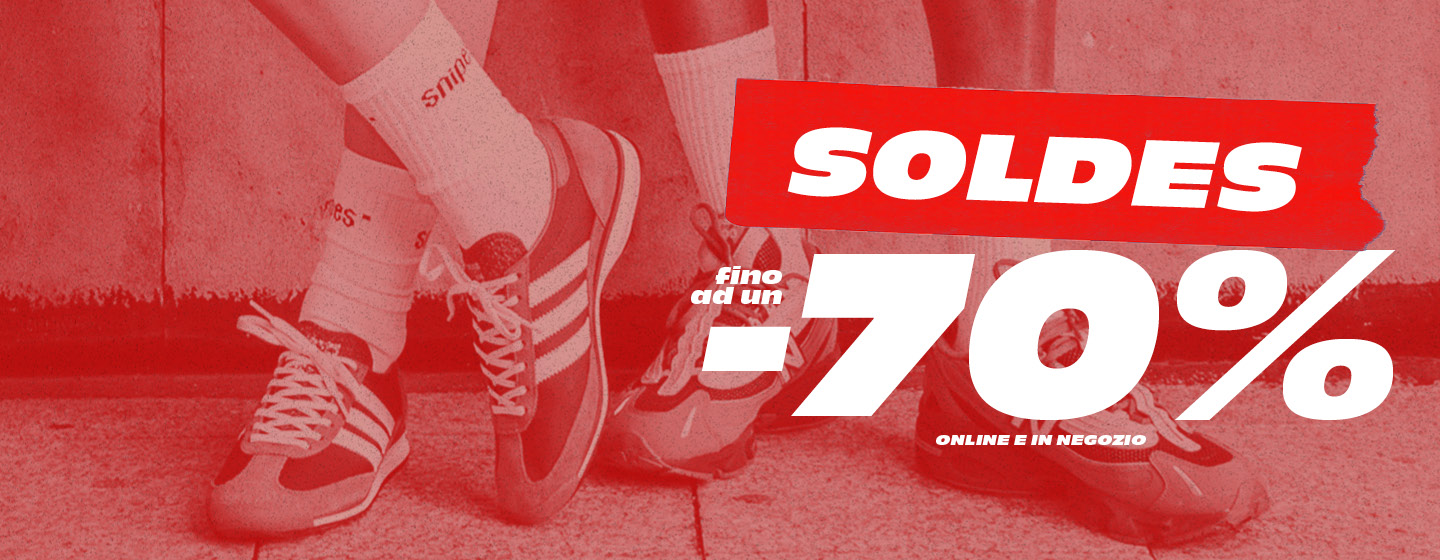 Models standing against concrete wall, wearing adidas and new balance sneakers and streetwear. Text: Summer Sale up to -70%