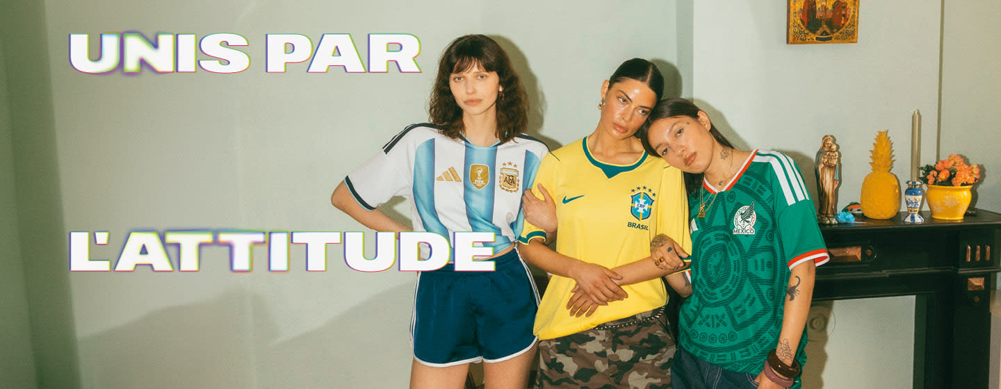 A diverse group of people posing outdoors at night wearing various international soccer jerseys, including teams like the Netherlands, Germany, Brazil, Morocco, Argentina, and Senegal. Large, bold white text on the right reads "UNIS PAR L'ATTITUDE."