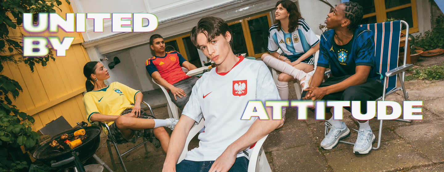 A promotional banner featuring five young individuals hanging out during a casual outdoor gathering in a backyard or patio setting. One person sits near a small charcoal grill with food cooking on it, while the others are seated around a patio table with food and drinks. They are all wearing different national football team jerseys, including France, Italy, Brazil, and Argentina. Large, stylized text overlays the image, with "UNITED BY" in the top-left corner and "ATTITUDE" across the bottom right, both featuring a bold white font with a soft neon glow.