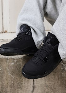 air jordan 4 Black Cat on concrete steps