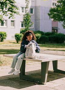 Graphic with a kiddressed sporty focusing on a backpack