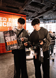 two people holding a SNIPES bag