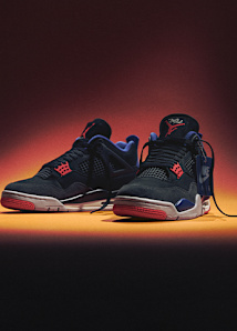 Air Jordan 4 Retro "RARE AIR" black and red, on a orange and black background