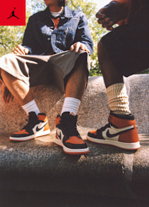 Men in urban environment wearing jordan apparel and jordan 1 sneakers