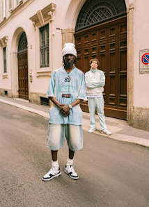 Men standing in the street wearing streetwear style clothing from Karl Kani