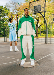 Men standing in a parking wearing a white and green tracksuit from the collaboration Sprite x SNIPES