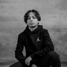 kid wearing black Air Jordan hoodie. 