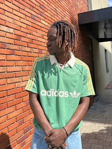Guy wearing a green adidas jersey