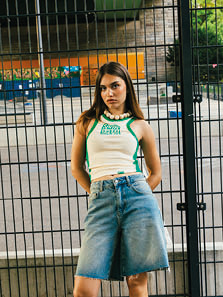 Female model wearing a Sprite x SNIPES Collection tanktop and Jeans shorts.