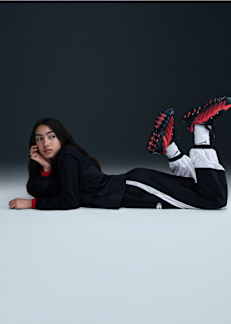 Teenage girl wearing red and black Nike Air Max DN