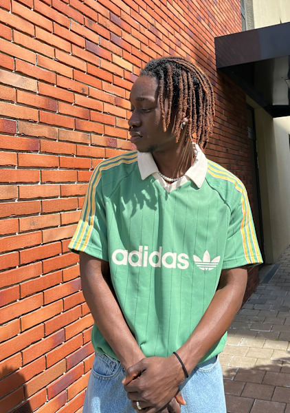 Guy wearing a green adidas jersey 
