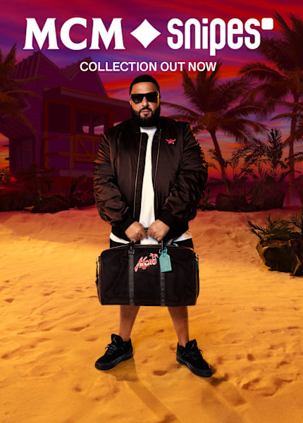 DJ Khaled wearing MCM x SNIPES bomber jacket and holding the branded black bag