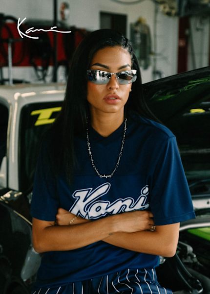 Girl model wearing Karl Kani blue logo t-shirt and sunglasses 