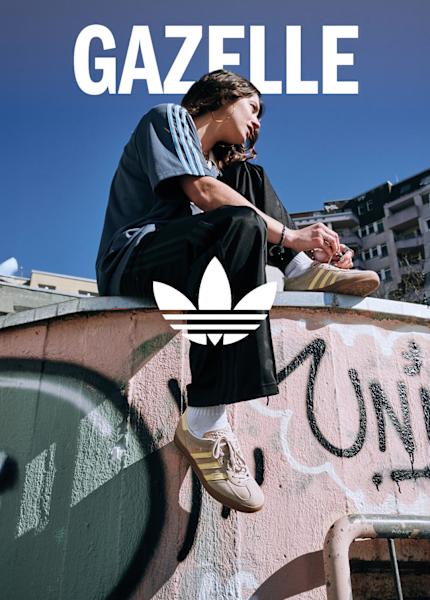 Girl sitting down with adidas clothing and shoes