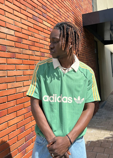 Guy wearing a green adidas jersey 