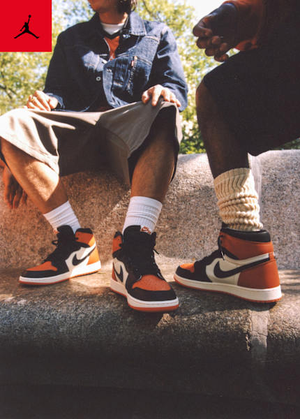 Men in urban environment wearing jordan apparel and jordan 1 sneakers
