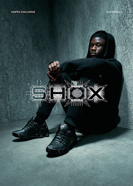 Model wearing nike Shox Z Sneakers in white and black