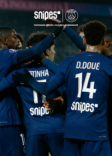 Football players in PSG uniform embracing each other on the field