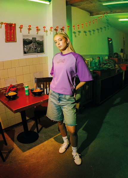 Woman wearing a purple tshirt standing