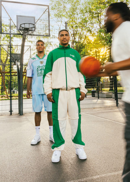 Guys playing basketball in a basketball field wearing clorhing from the collab Sprite x SNIPES