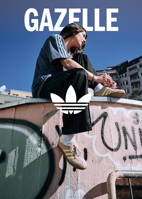 woman sitting on roof wearing adidas apparel and Gazelle shoes