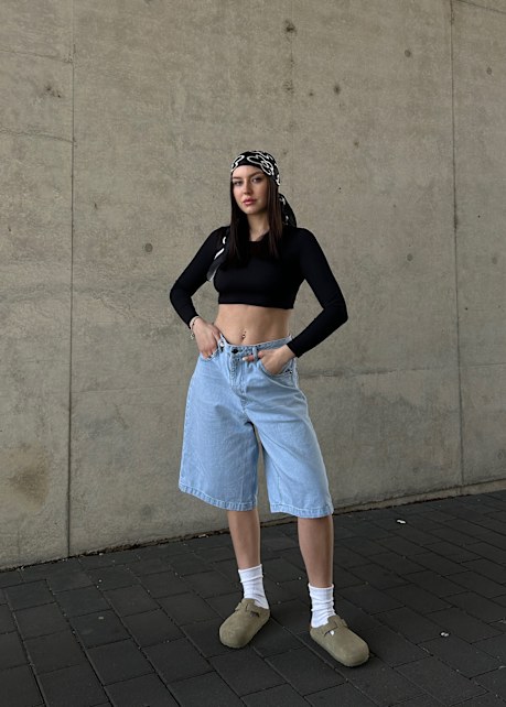 Girl wearing some jorts and boston with a bandand