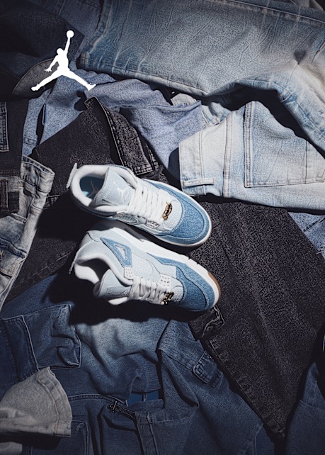 Jordan sneaker light blue and white laying on a bunch of jeans