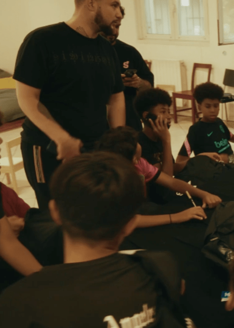 Group of children from back to school project sitting in class room and opening backpacks with school supplies
