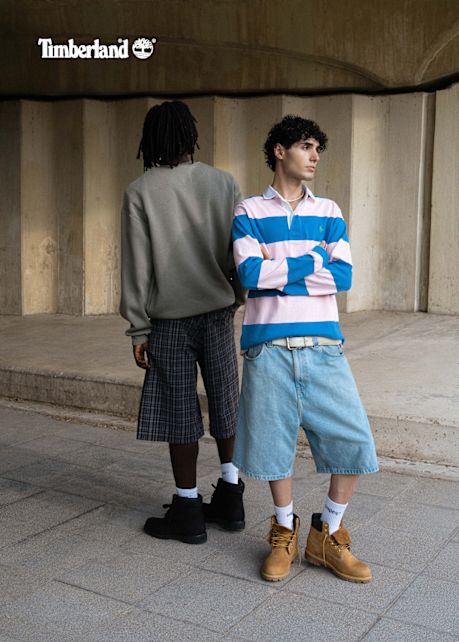 Models wearing timberland 6 inch boots and streetwear while posing underneath a bridge