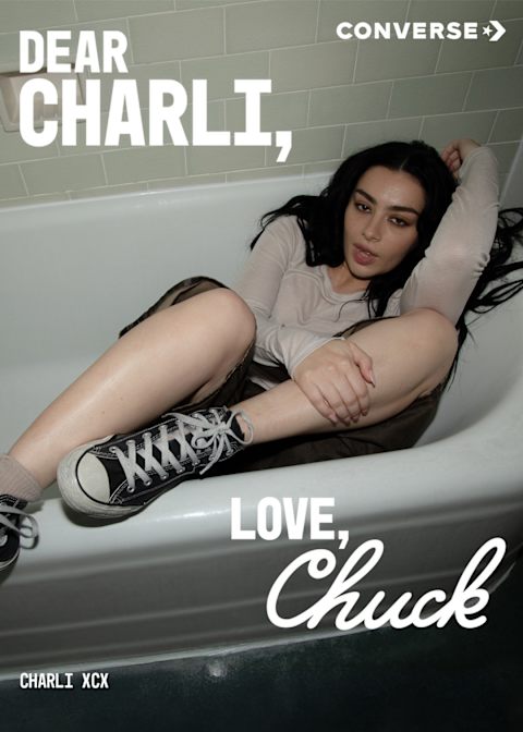 Charlie XCX sitting in a bathtub with the wording 'Dear Charlie, Love Chuck'