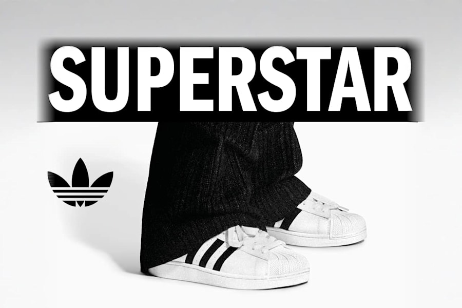 black and white image of actor Samuel L. Jackson wearing white adidas Superstar II sneakers and black suit